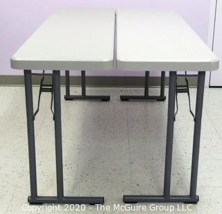 Set of (2) Industrial Heavy Duty Plastic Folding Tables Made by National Public Seating.   There are four lots of these tables for a total of 8 tables .  Each measure approximately 18" W, 30" T  & 60" long.  Room 20 Kitchen