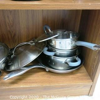 Wood Book Shelf Full of Cleaning & Entertaining Items Including Several Blenders, and Cookware.  Room 20 Kitchen