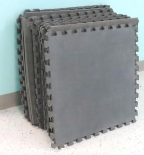 Group of 20 Interlocking Grey Foam Floor Cushioning Tiles.  Measure 24" x 24".  -  Room 8