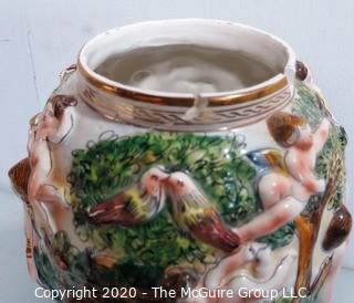 Vintage Porcelain Hand Painted Italian Capodimonte Urn with Lid and Handles with Frolicking Figurals & Cherubs. Several Repairs and chips. Measures approximately 17" tall with lid. 
