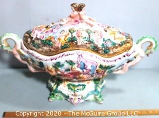 Vintage Porcelain Hand Painted Italian Capodimonte Centerpiece Covered Dish with Lid and Handles with Frolicking Figurals & Cherubs.  Measures approximately 22" long and 16"tall with lid. 
