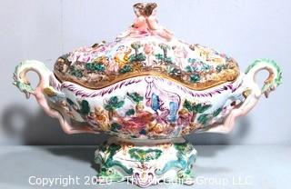 Vintage Porcelain Hand Painted Italian Capodimonte Centerpiece Covered Dish with Lid and Handles with Frolicking Figurals & Cherubs.  Measures approximately 22" long and 16"tall with lid. 
