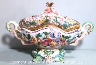 Vintage Porcelain Hand Painted Italian Capodimonte Centerpiece Covered Dish with Lid and Handles with Frolicking Figurals & Cherubs.  Measures approximately 22" long and 16"tall with lid. 
