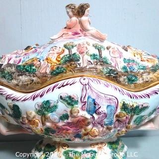 Vintage Porcelain Hand Painted Italian Capodimonte Centerpiece Covered Dish with Lid and Handles with Frolicking Figurals & Cherubs.  Measures approximately 22" long and 16"tall with lid. 
