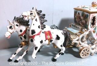 Vintage Porcelain Hand Painted Italian Capodimonte Horse & Carriage with Lidded Container.  Horses have a repair and one missing foot.  Measures approximately 14" tall with lid and 30" long. 
