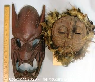 Two Hand Carved African Masks, One with Feathers