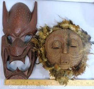 Two Hand Carved African Masks, One with Feathers