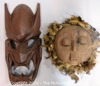 Two Hand Carved African Masks, One with Feathers