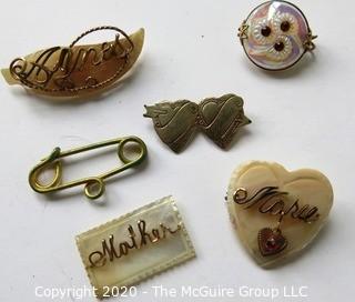 Five Pieces of Vintage Personalized Jewelry.  Four Mother of Pearl with Gold Script One Silver Entwined Hearts.   One piece needs repair. 
