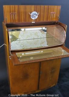 1930's Art Deco: Rivington Cabinet Works (London) Mid Century Dry Bar with Lighted Fold down door and mirrored panels with accessories.  Measures approximately 42"W 31"T 15"D. Vintage Furniture