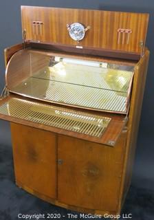 1930's Art Deco: Rivington Cabinet Works (London) Mid Century Dry Bar with Lighted Fold down door and mirrored panels with accessories.  Measures approximately 42"W 31"T 15"D. Vintage Furniture