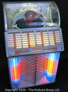 Wurlitzer Jukebox, 1954 Model F-1700, restored with manual and 45 rpm records.  In addition, (2) Matching Art Deco Vintage Wurlitzer Model 5205 Remote Wall Box Table Top Jukeboxes; 12 x 12 7.5"D32"W x 28"D x 56"T