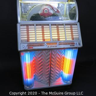 Wurlitzer Jukebox, 1954 Model F-1700, restored with manual and 45 rpm records.  In addition, (2) Matching Art Deco Vintage Wurlitzer Model 5205 Remote Wall Box Table Top Jukeboxes; 12 x 12 7.5"D32"W x 28"D x 56"T