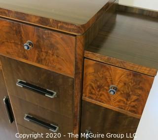 Art Deco Tallboy Dresser Made of Highly Figured Book-Matched Veneer.  5 center drawers flanked by doors (matching pieces to the set are found in Lots 83 and 84) 