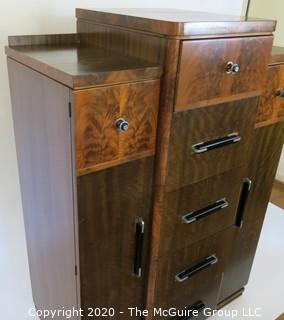 Art Deco Tallboy Dresser Made of Highly Figured Book-Matched Veneer.  5 center drawers flanked by doors (matching pieces to the set are found in Lots 83 and 84) 