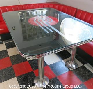 Furniture: 1950's style "Diner" booth with two-piece corner banquette, 2 red stools, 2 black stools and glass topped chrome table on 4 pedestal feet.  Table is 48" x 68" x 31"T; Banquette is 73" end to wall x 90" end to wall. Banquette is 30.5" tall at back x 17.5" seat height.  Stools are 21"T. Note: photo shows 1.5" worn banquette seat.   