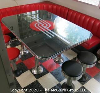 Furniture: 1950's style "Diner" booth with two-piece corner banquette, 2 red stools, 2 black stools and glass topped chrome table on 4 pedestal feet.  Table is 48" x 68" x 31"T; Banquette is 73" end to wall x 90" end to wall. Banquette is 30.5" tall at back x 17.5" seat height.  Stools are 21"T. Note: photo shows 1.5" worn banquette seat.   