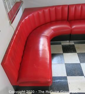 Furniture: 1950's style "Diner" booth with two-piece corner banquette, 2 red stools, 2 black stools and glass topped chrome table on 4 pedestal feet.  Table is 48" x 68" x 31"T; Banquette is 73" end to wall x 90" end to wall. Banquette is 30.5" tall at back x 17.5" seat height.  Stools are 21"T. Note: photo shows 1.5" worn banquette seat.   