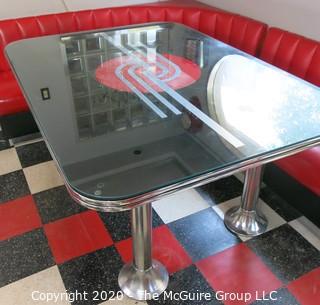 Furniture: 1950's style "Diner" booth with two-piece corner banquette, 2 red stools, 2 black stools and glass topped chrome table on 4 pedestal feet.  Table is 48" x 68" x 31"T; Banquette is 73" end to wall x 90" end to wall. Banquette is 30.5" tall at back x 17.5" seat height.  Stools are 21"T. Note: photo shows 1.5" worn banquette seat.   