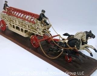 Vintage Cast Iron Fire Ladder Carriage Toy Mounted on Board.  Measures approximately 31" long with chains to attach to ceiling. 