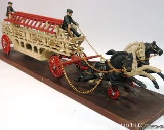 Vintage Cast Iron Fire Ladder Carriage Toy Mounted on Board.  Measures approximately 31" long with chains to attach to ceiling. 