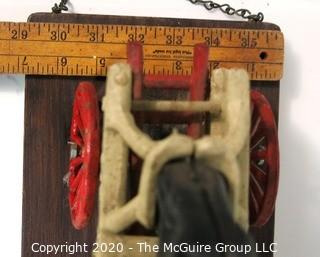 Vintage Cast Iron Fire Ladder Carriage Toy Mounted on Board.  Measures approximately 31" long with chains to attach to ceiling. 