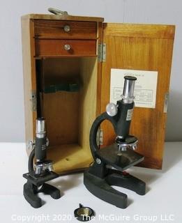 Two Scientific Microscopes with Wood Case and Specimen Slides; sold by Research Microscopes of Mameroneck, NY