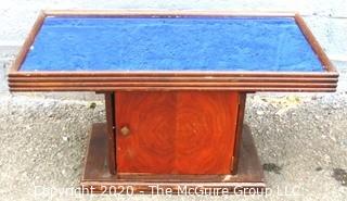 Vintage Art Deco Coffee Table with Bar Cabinet Base and Blue Glass Mirror Top.  Measures approximately 33" long and 18 Wide.  Some separation of top from base, but should be easy to repair