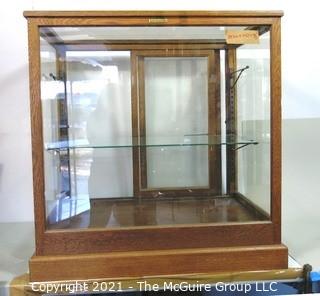 Vintage Glass & Oak Floor Model Showcase Made by Columbus Show Case With Glass Shelf (note chip on corner) and Sliding Case Lock with Key.  Measures approximately 34 1/2" x 24" x 37"T {Note: Description Altered 2/3/2021 @ 10:23 am ET}