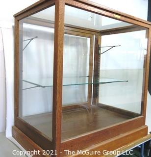 Vintage Glass & Oak Floor Model Showcase Made by Columbus Show Case With Glass Shelf (note chip on corner) and Sliding Case Lock with Key.  Measures approximately 34 1/2" x 24" x 37"T {Note: Description Altered 2/3/2021 @ 10:23 am ET}