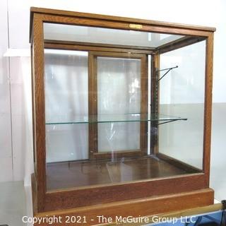 Vintage Glass & Oak Floor Model Showcase Made by Columbus Show Case With Glass Shelf (note chip on corner) and Sliding Case Lock with Key.  Measures approximately 34 1/2" x 24" x 37"T {Note: Description Altered 2/3/2021 @ 10:23 am ET}