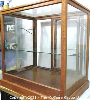 Vintage Glass & Oak Floor Model Showcase Made by Columbus Show Case With Glass Shelf (note chip on corner) and Sliding Case Lock with Key.  Measures approximately 34 1/2" x 24" x 37"T {Note: Description Altered 2/3/2021 @ 10:23 am ET}