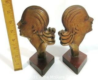 Pair of Art Deco Female Busts in Profile Relief Mounted on Wood Base. Possibly D. H. Chiparus.  Measures approximately 7 1/2" tall