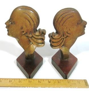 Pair of Art Deco Female Busts in Profile Relief Mounted on Wood Base. Possibly D. H. Chiparus.  Measures approximately 7 1/2" tall