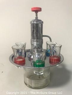 Fun Mid Century Liquor Decanter with Pump Dispenser and  Six Glasses on Base.   Measures approximately 12" tall.