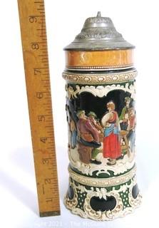 Antique German Porcelain Stein with Pewter lid. Measures approximately 10" tall.