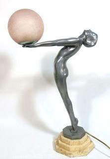 Art Deco Pewter Lamp of Woman with Outstretched Arms Holding Pink Glass Globe Shade on Marble Base.  Measures approximately 25" tall.  