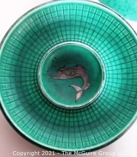 (2) Gustavsberg Argenta Stoneware Pottery Trays or Plates Designed by Wilhelm Kage with Silver Lion and Fish on Jade Green Base. Measures approximately 7" in diameter.