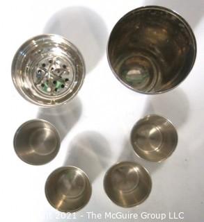 Small Silver Plated Cocktail Shaker with Four Matching Cups. Made in Germany.  Measures approximately 6 1/2" tall and each small cup has different color enamel edge decoration.