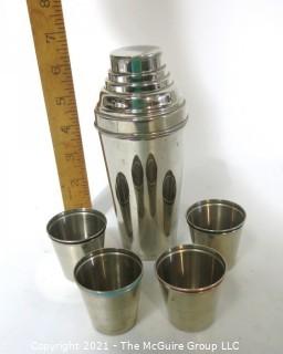 Small Silver Plated Cocktail Shaker with Four Matching Cups. Made in Germany.  Measures approximately 6 1/2" tall and each small cup has different color enamel edge decoration.