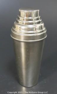 Small Silver Plated Cocktail Shaker with Four Matching Cups. Made in Germany.  Measures approximately 6 1/2" tall and each small cup has different color enamel edge decoration.