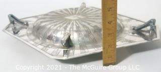 Two Piece Vintage Art Deco Silver Plate Serving Dish with Lid Made by Weidlich Bros with Geometric Design. Marked BMMTS for Britannia Metal Mounts.  Measures approximately 13" long