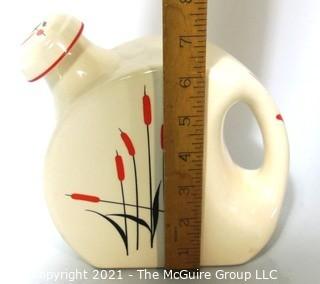  Vintage Disc Pottery Pitcher with Stopper Made by Sears & Roebuck in the Cat Tail Pattern.  Measures approximately 8" tall.