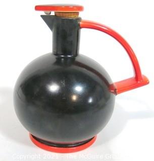 Vintage Black & Red Art Deco Pottery Jug with Cork Stopper.  Makers Mark on Bottom.  It measures approximately 6 1/2" tall.