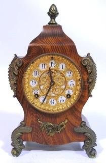 Antique 1904 Ansonia Calais Louis XIV Style 8 Day Mantel Clock in Faux Wood Grained Case.  It measures approximately  7 1/2 inches wide, 14 inches tall & 4 1/2 inches deep.