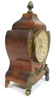 Antique 1904 Ansonia Calais Louis XIV Style 8 Day Mantel Clock in Faux Wood Grained Case.  It measures approximately  7 1/2 inches wide, 14 inches tall & 4 1/2 inches deep.