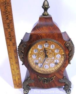 Antique 1904 Ansonia Calais Louis XIV Style 8 Day Mantel Clock in Faux Wood Grained Case.  It measures approximately  7 1/2 inches wide, 14 inches tall & 4 1/2 inches deep.