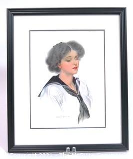 Framed Under Glass Lithograph of Woman by C. Coles Phillips.  Measures approximately 16" x 13".
