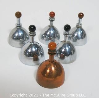 Set of 6 Mid Century Modern Chrome & Copper Dinner Service Hand Bells with Bakelite Decoration made by Chase. They Measure approximately 2 7/8" tall.