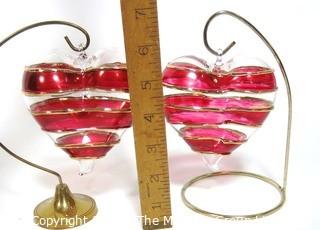 Two Large Hand Blown Clear with Red and Gold Overlay Venetian Glass Puffy Hearts with Stand.  Each measure approximately 4" wide.  